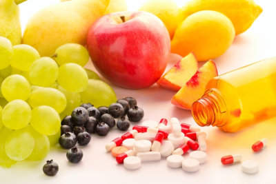 Vitamin pills with fresh fruits